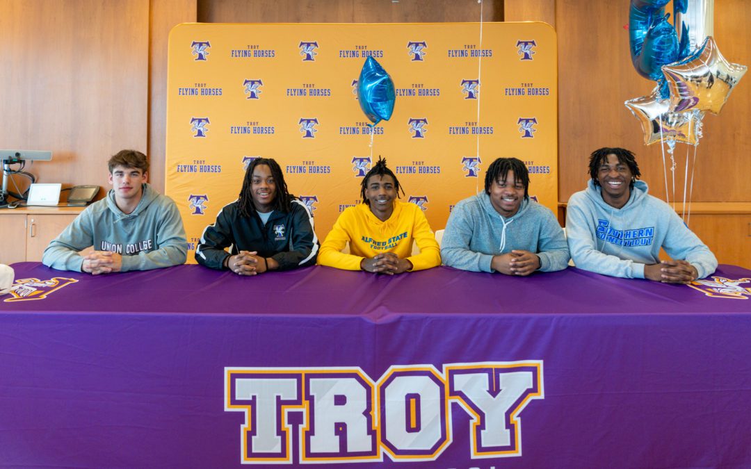 Varsity football players commit to play in college
