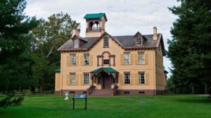 The home of Martin Van Buren. A tan home in a green field surrounded by trees